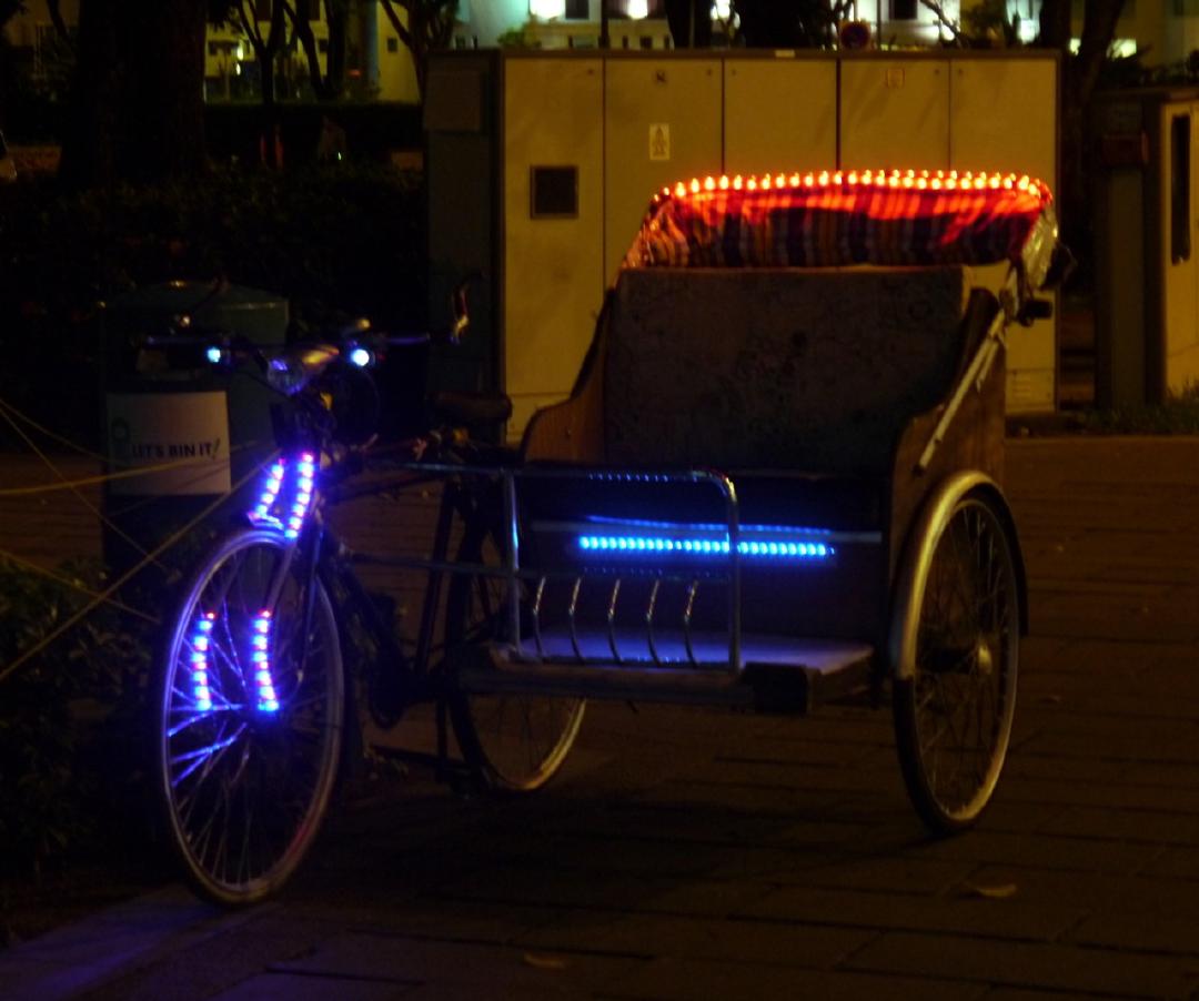 Bike rickshaw with lights and thumping stereo system.