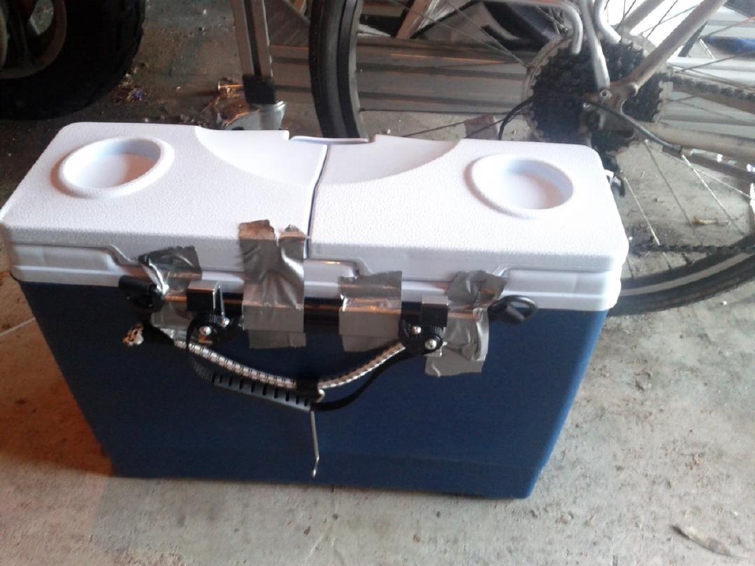 Made a very simple bike-mounted cooler. Arkel pannier hooks plus two bolts, fender washers to spread the force, rubber washers...