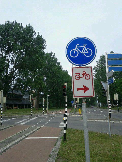 Oddly, motorcycles can usually share the bike paths (this sign is an exception)
