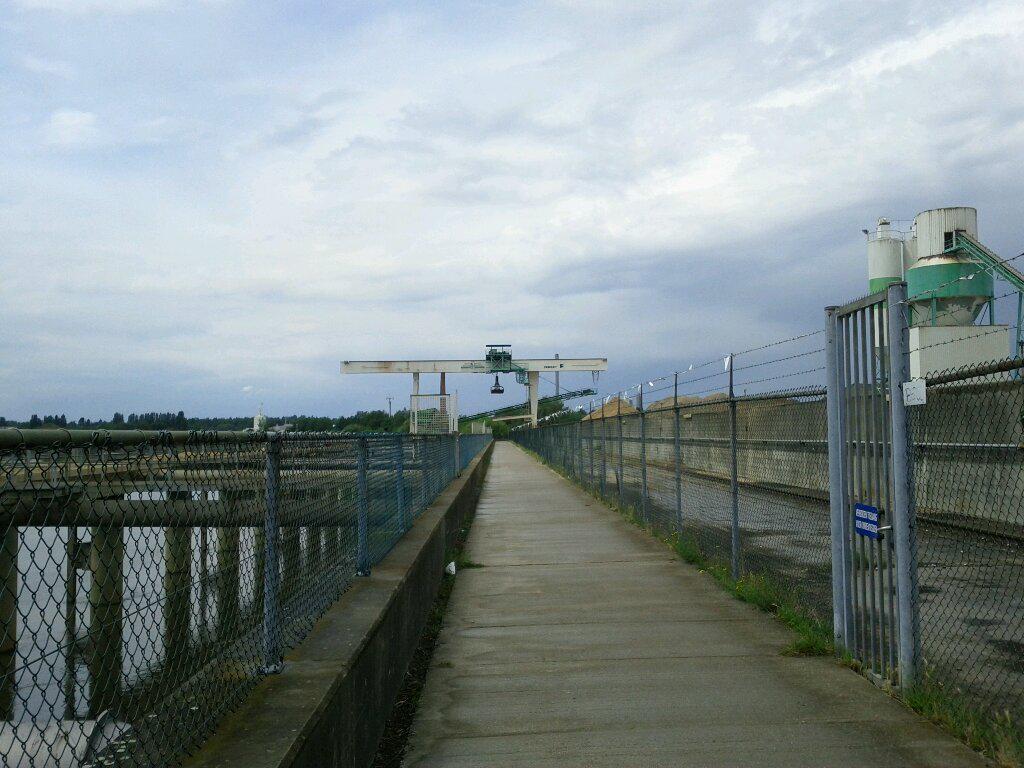 Strange bike path through industrial yard-- sort of looks like that sky-claw is waiting to pick me up.
